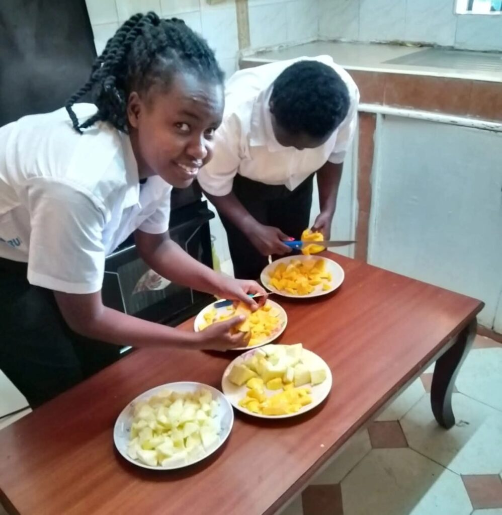 Learners engaging in a hands-on food preparation activity at Holmeside School