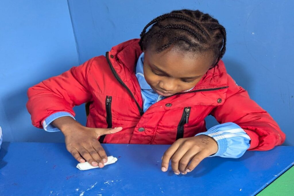 A leaner participating in fine motor activities at Holmeside School